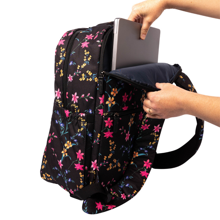 hand putting laptop into back pocket of alimasy black floral womens laptop work backpack