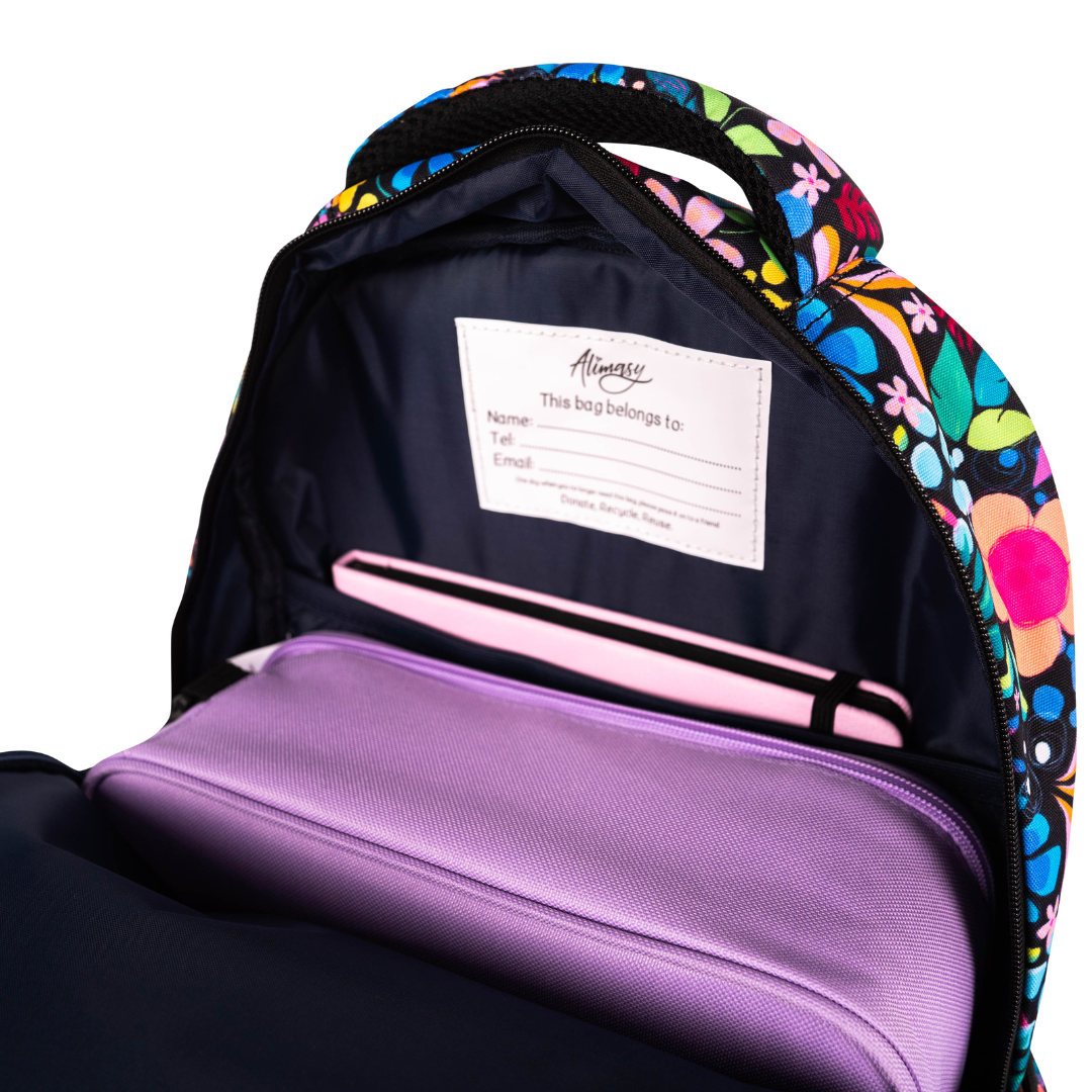 inside of alimasy black floral wonderland large backpack with purple lunchbox and pink notebook