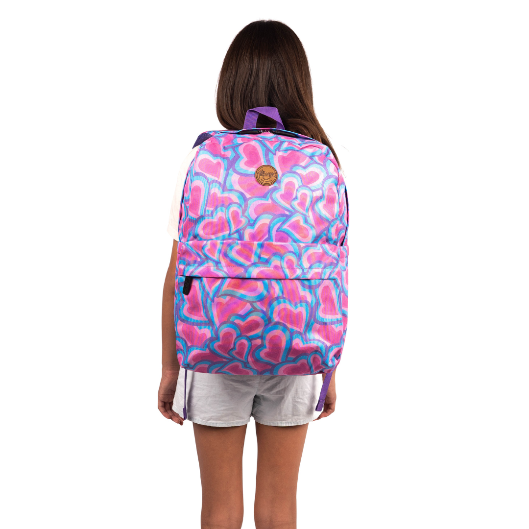 girl wearing alimasy pink heart large backpack on back