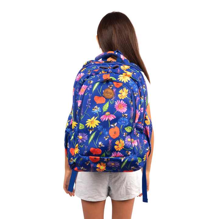 girl wearing blue alimasy bees and flower school backpack