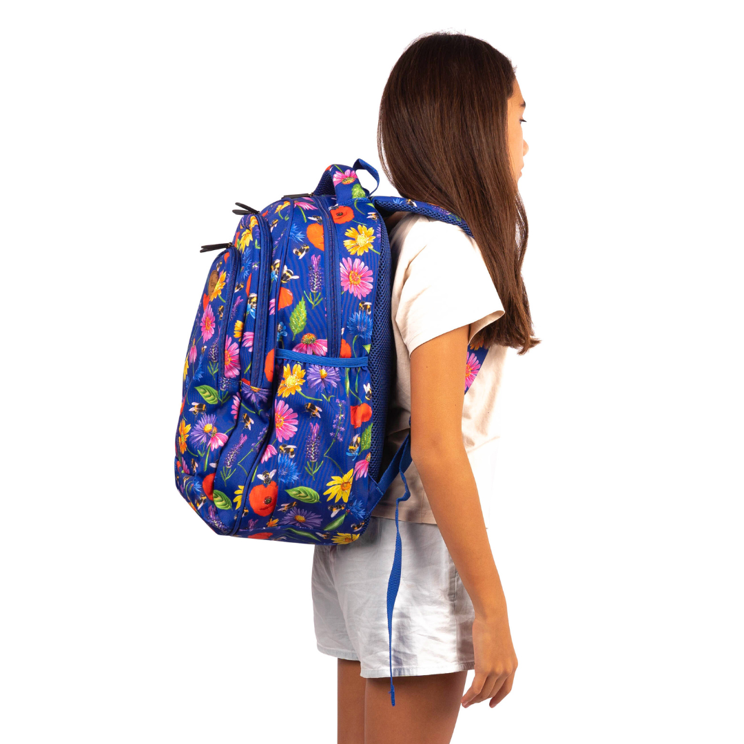side view of girl wearing alimasy blue bees and flowers school backpack