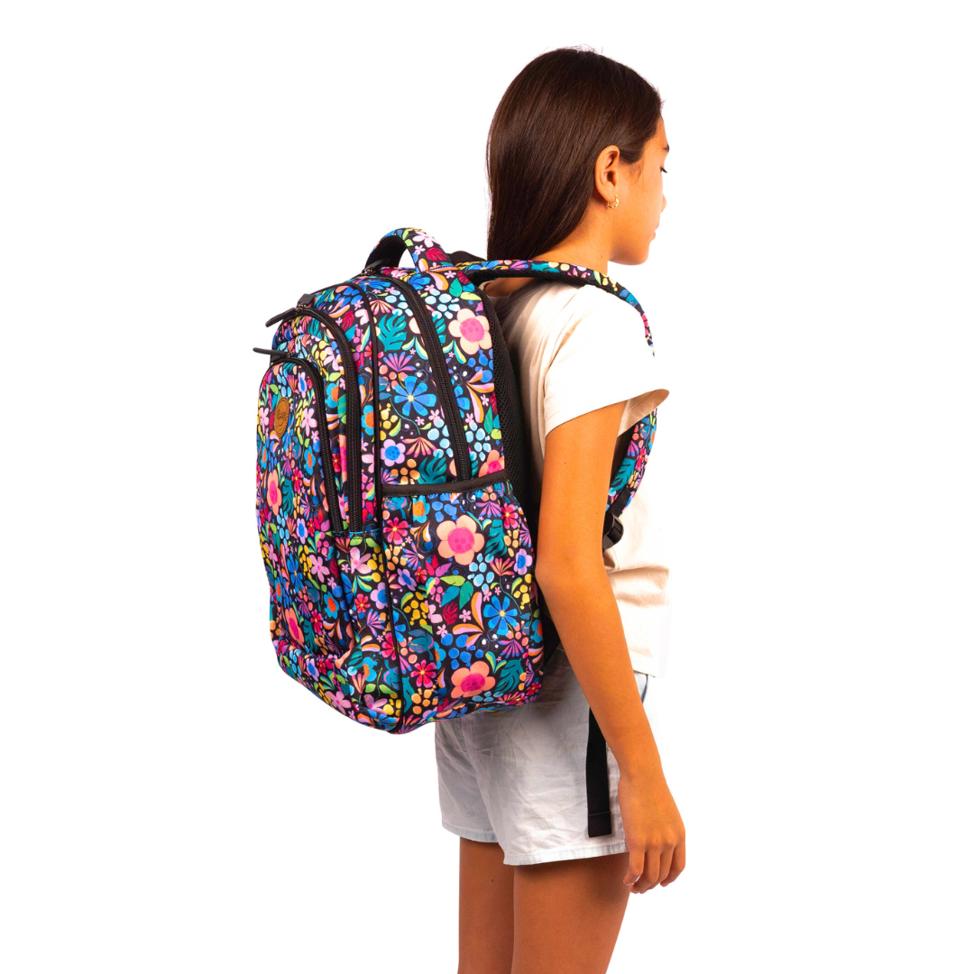 side view of girl wearing alimasy black floral kasey rainbow wonderland print large backpack