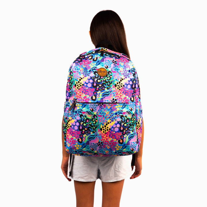 girl wearing on her back alimasy rainbow coloured loepard print laptop backpack for australian women